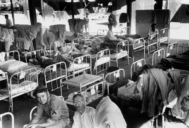 US and Filipino troops, victims of Japanese bombing attacks on Bataan, Philippines, in an open air field hospital after receiving medical treatment on April 11, 1942. Limited for space, the hospital at all times had patients that needed attention. (AP Photo)